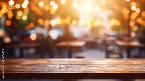 Wooden table in front of abstract blurred restaurant lights background