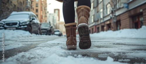 Woman in winter boots walking in the city.
