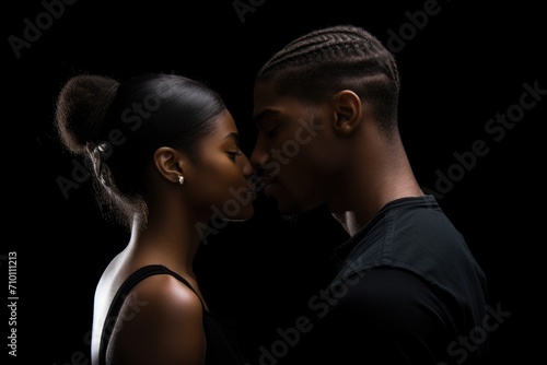 Black History Month, Dramatic side view of two young African American people on black background