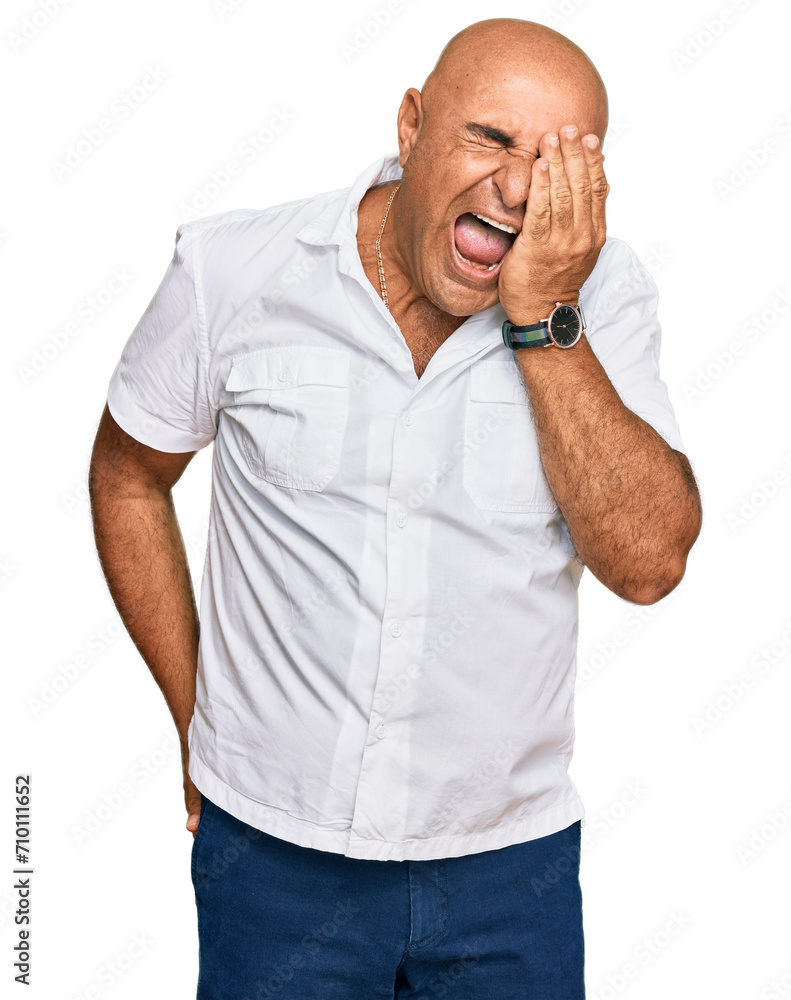Mature middle east man with mustache wearing casual white shirt yawning tired covering half face, eye and mouth with hand. face hurts in pain. Mature middle east man with mustache wearing casual white shirt yawning tired covering half face, eye and mouth with hand. face hurts in pain.