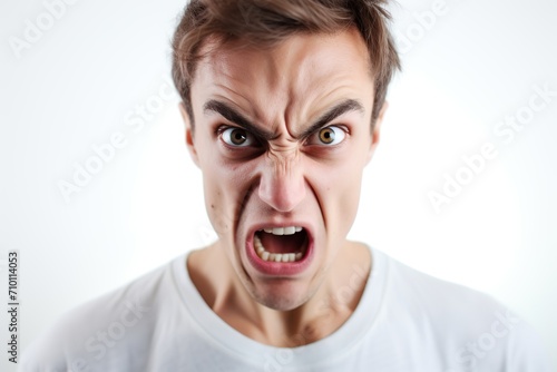 Portrait of young angry man on white background