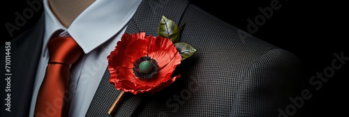 Poppy flower in the buttonhole of a man's jacket, a remembrance poppy in memory of fallen soldiers in the war, banner