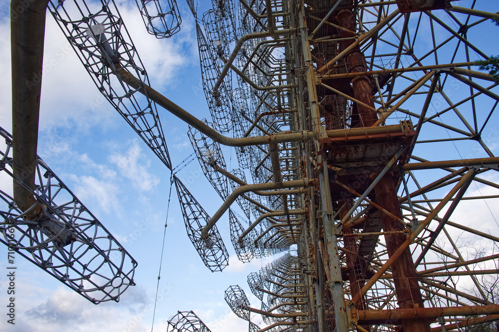 An array of tall, rusting structures with intricate wiring. Duga is a Soviet over-the-horizon radar station for an early detection system for ICBM launches.