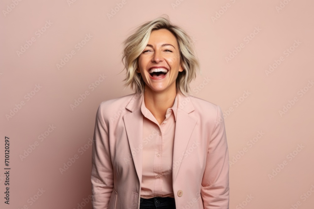 Portrait of a happy mature businesswoman laughing against pink background. Portrait of a happy mature businesswoman laughing against pink background.