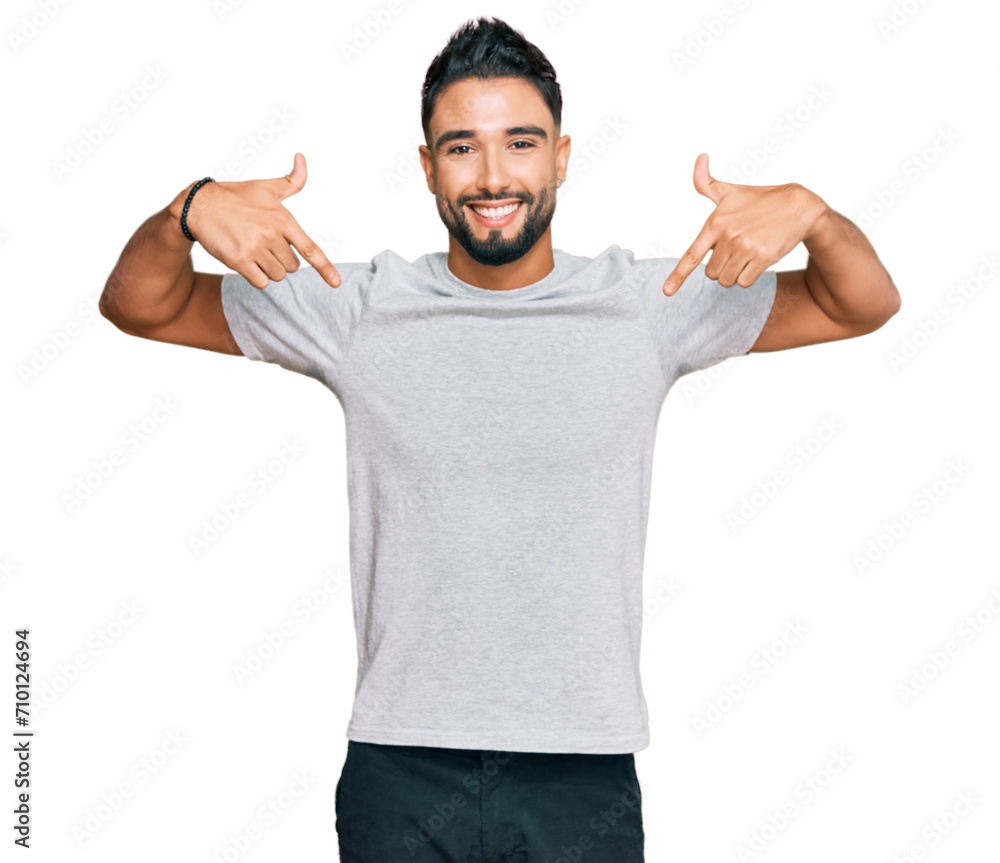 Young man with beard wearing casual grey tshirt looking confident with smile on face, pointing oneself with fingers proud and happy. Young man with beard wearing casual grey tshirt looking confident with smile on face, pointing oneself with fingers proud and happy.