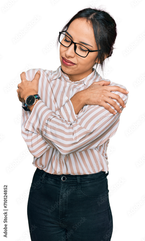 Young hispanic girl wearing casual clothes and glasses hugging oneself happy and positive, smiling confident. self love and self care Young hispanic girl wearing casual clothes and glasses hugging oneself happy and positive, smiling confident. self love and self care