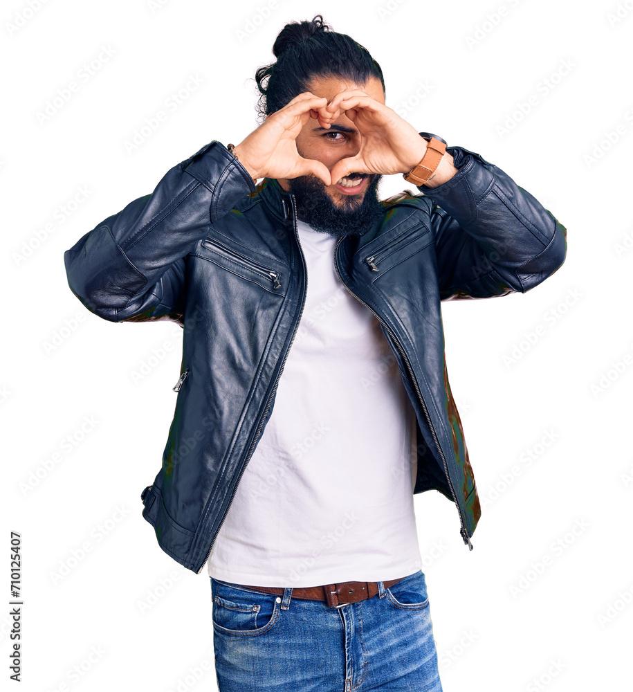 Young arab man wearing casual leather jacket doing heart shape with hand and fingers smiling looking through sign Young arab man wearing casual leather jacket doing heart shape with hand and fingers smiling looking through sign