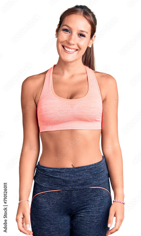 Young beautiful hispanic woman wearing sportswear with a happy and cool smile on face. lucky person. Young beautiful hispanic woman wearing sportswear with a happy and cool smile on face. lucky person.
