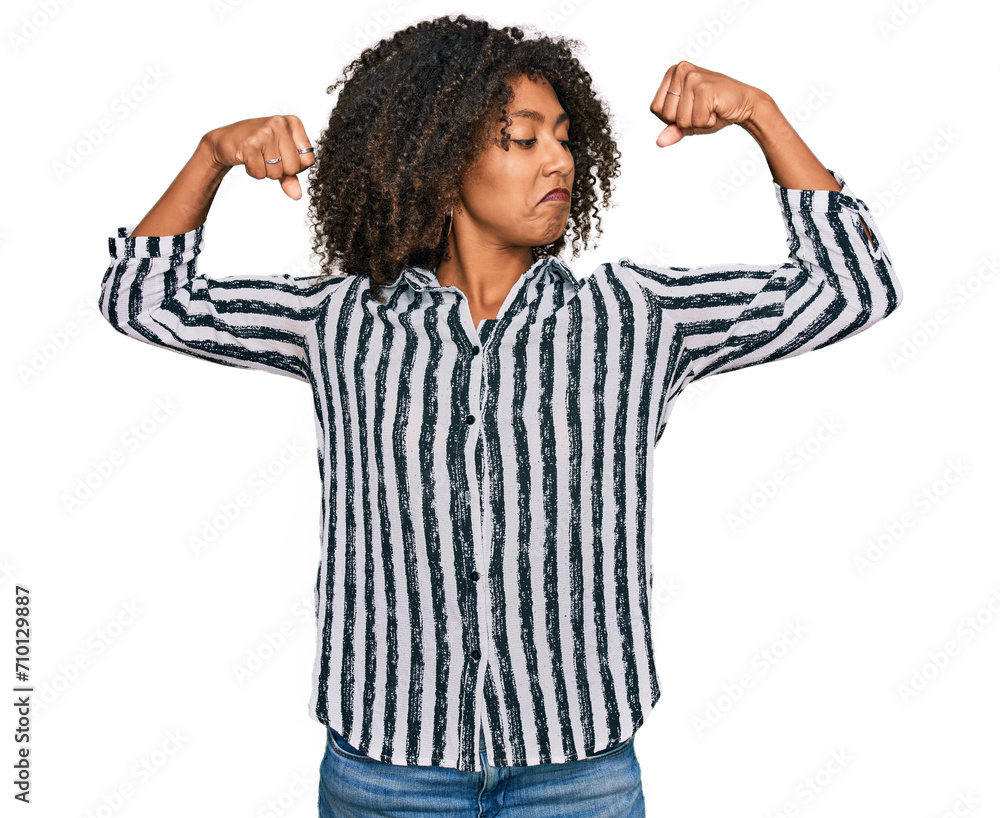 Young african american girl wearing casual clothes showing arms muscles smiling proud. fitness concept. Young african american girl wearing casual clothes showing arms muscles smiling proud. fitness concept.