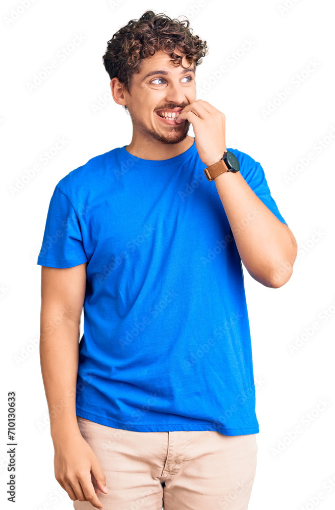 Young handsome man with curly hair wearing casual clothes looking stressed and nervous with hands on mouth biting nails. anxiety problem. Young handsome man with curly hair wearing casual clothes looking stressed and nervous with hands on mouth biting nails. anxiety problem.