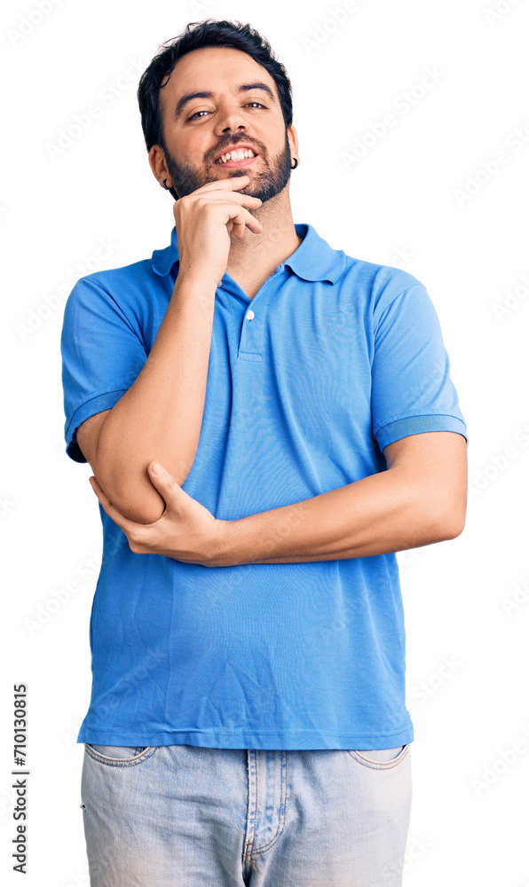 Young hispanic man wearing casual clothes looking confident at the camera with smile with crossed arms and hand raised on chin. thinking positive. Young hispanic man wearing casual clothes looking confident at the camera with smile with crossed arms and hand raised on chin. thinking positive.