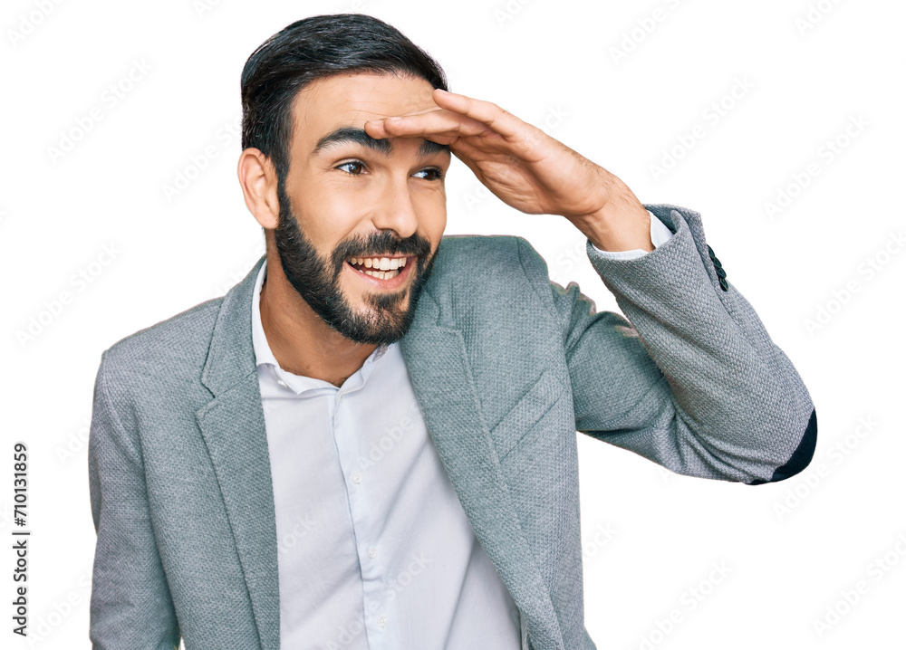 Young hispanic man wearing business clothes very happy and smiling looking far away with hand over head. searching concept. Young hispanic man wearing business clothes very happy and smiling looking far away with hand over head. searching concept.