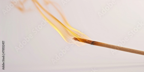 A close up image of a burning matchstick. Perfect for illustrating concepts such as ignition, fire, danger, or lighting a candle. © Fotograf