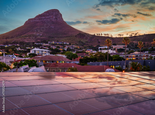 Lion's Head after sunset with solar panels on the roof reflecting the sunset sky, Cape Town, South Africa