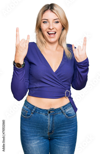 Young caucasian woman wearing casual clothes shouting with crazy expression doing rock symbol with hands up. music star. heavy concept.