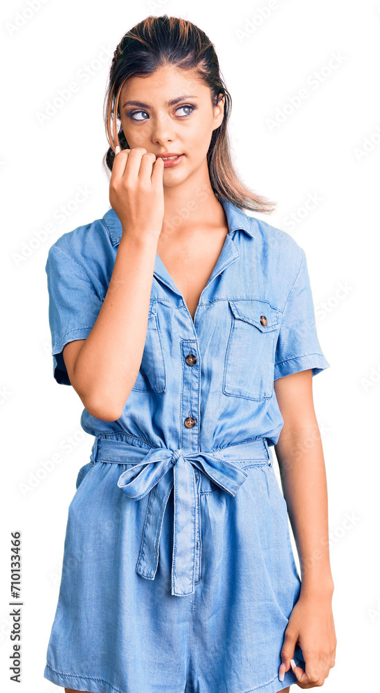 Young beautiful woman wearing casual clothes looking stressed and nervous with hands on mouth biting nails. anxiety problem. Young beautiful woman wearing casual clothes looking stressed and nervous with hands on mouth biting nails. anxiety problem.