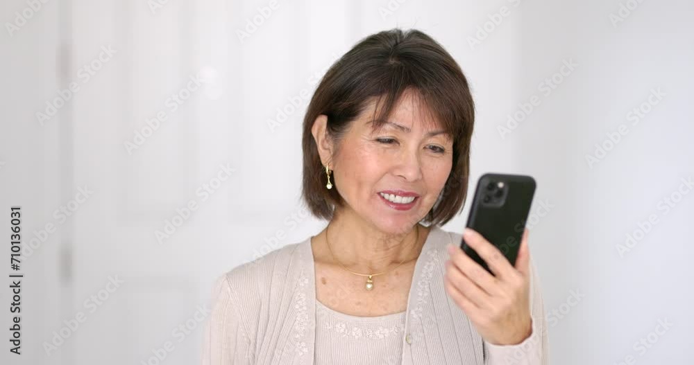 Closeup happy attractive woman smiling enjoying looking at mobile phone laughing talking using face time video chat closeup. Closeup happy attractive woman smiling enjoying looking at mobile phone laughing talking using face time video chat closeup.