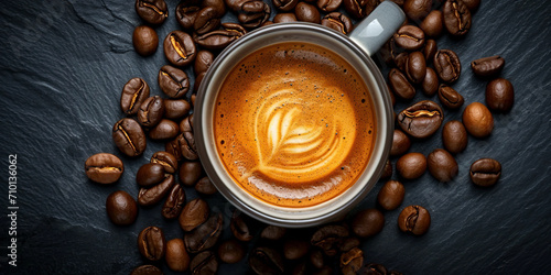 Top view of an espresso with coffee foam in a cup on a dark background of coffee beans