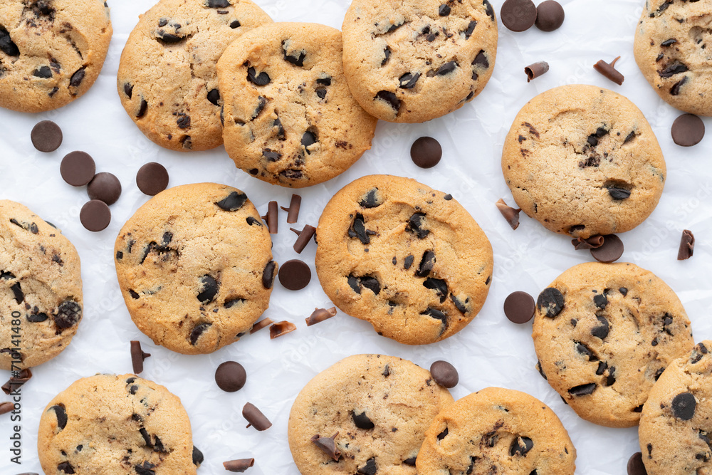 Cookies with chocolate drops on white crumpled paper. Cookies background. Close-up, top view, flat lay Cookies with chocolate drops on white crumpled paper. Cookies background. Close-up, top view, flat lay