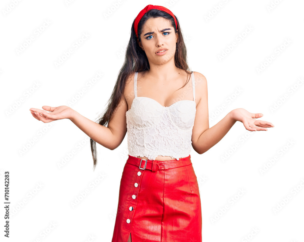 Brunette teenager girl wearing elegant look clueless and confused expression with arms and hands raised. doubt concept. Brunette teenager girl wearing elegant look clueless and confused expression with arms and hands raised. doubt concept.