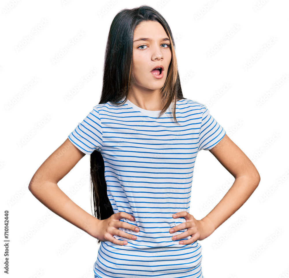 Young brunette girl with long hair with arms akimbo in shock face, looking skeptical and sarcastic, surprised with open mouth Young brunette girl with long hair with arms akimbo in shock face, looking skeptical and sarcastic, surprised with open mouth