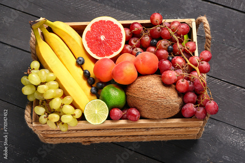 Fototapeta Naklejka Na Ścianę i Meble -  Box with different fresh fruits on black wooden background