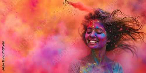 Young Woman Celebrating Holi, enjoying the colorful clouds of holi powder, hindu festive in India 