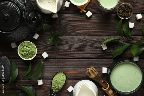 Frame made of matcha tea, accessories and plant branches on dark wooden background