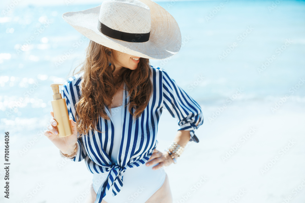happy modern woman on ocean coast with spf