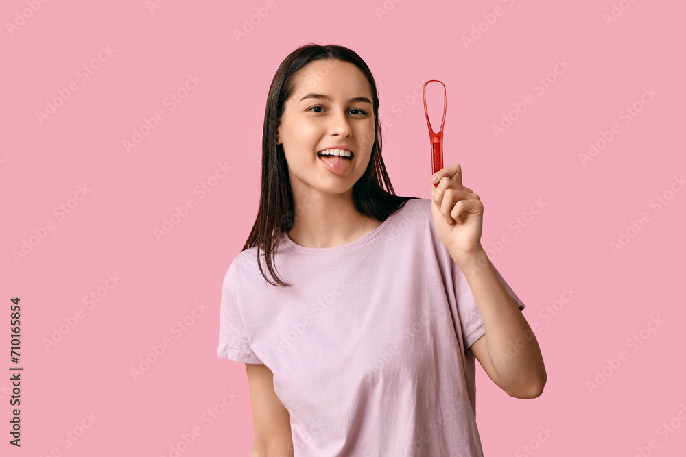 Beautiful young woman with tongue scraper on pink background Beautiful young woman with tongue scraper on pink background