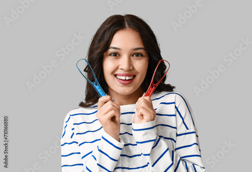 Smiling young woman holding...