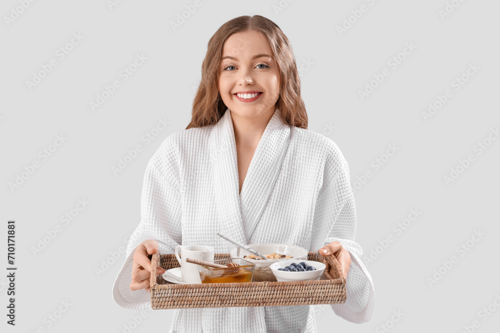Young woman with tasty breakfast on light background. Valentine's Day celebration Young woman with tasty breakfast on light background. Valentine's Day celebration
