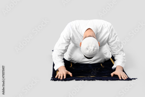 Young Muslim man praying on...