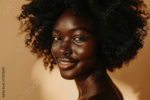Beautiful African American woman with clean, healthy skin and curly black hair.