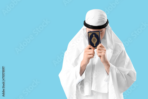 Young Muslim man with Koran...