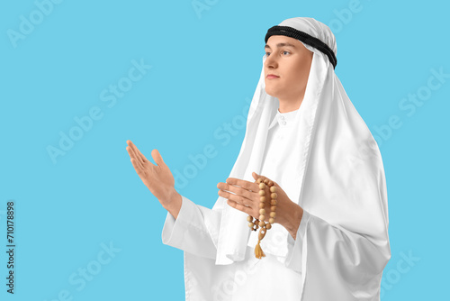 Young Muslim man with prayi...