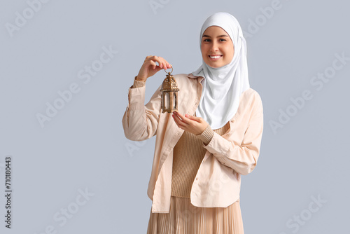 Young Muslim woman with lam...