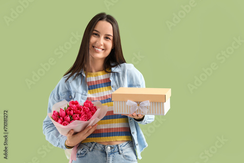 Smiling young woman holding...