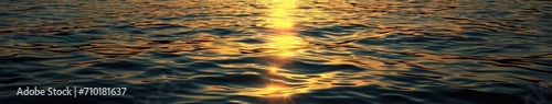 The sun shines out into the water at sunset
