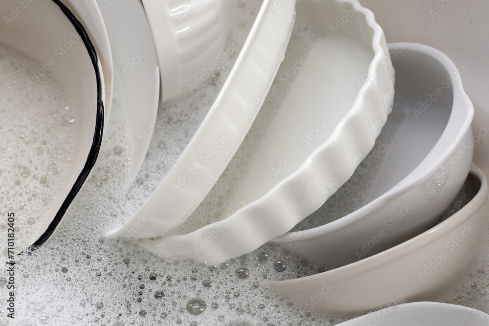 Dish washing, Dirty dishes soaking in kitchen sink. Dish washing, Dirty dishes soaking in kitchen sink.