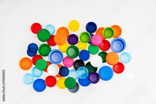 Pile of plastic caps of different colors - Bottle caps to recycle