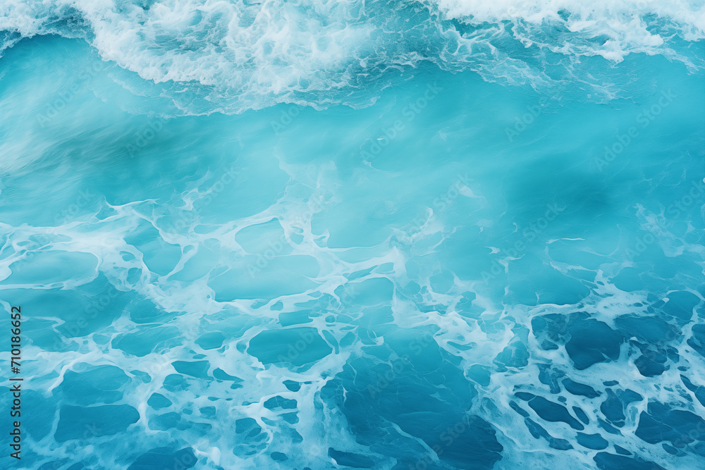 From above aerial view of turquoise ocean water with splashes and foam for abstract natural background and texture