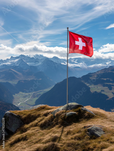 Die Schweizer Flagge auf dem Gipfel eines Berges in den Schweizer Alpen mit einem herrlichen Panorama im Hintergrund