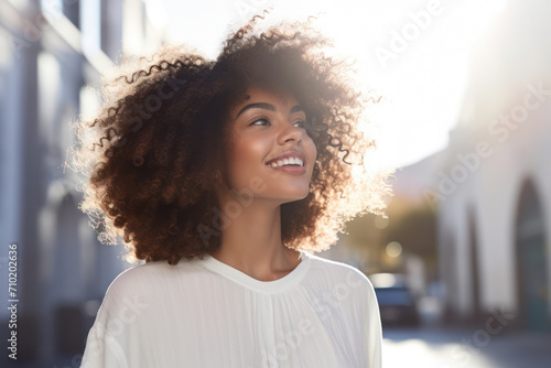 Happy Lady: Fashionable Afro-Beauty, Smiling with Joy, Posing Outdoors in Modern City © SHOTPRIME STUDIO