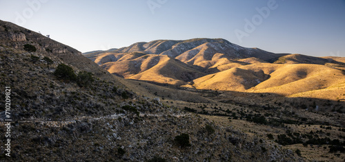 Sunlight Covers Rolling HIlls In Guadalupe Moutains © kellyvandellen