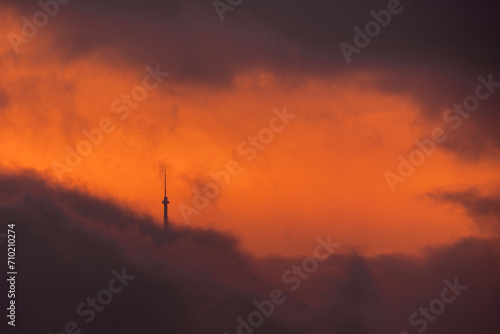 Tower silhouette lost in the orange clouds