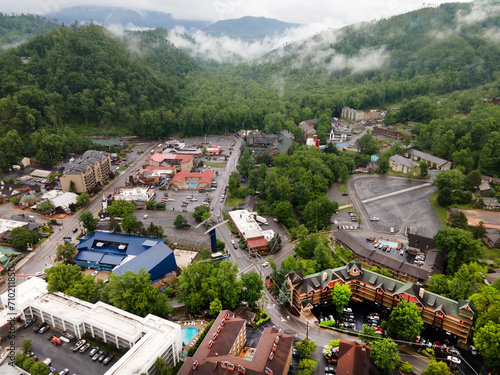 city of Gatlinburg in Tennessee and the Great Smoky Mountains from a bird's eye view, a tourist mecca with hotels, parking and shops. photo