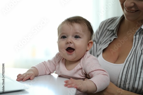 Young woman with her cute baby at home