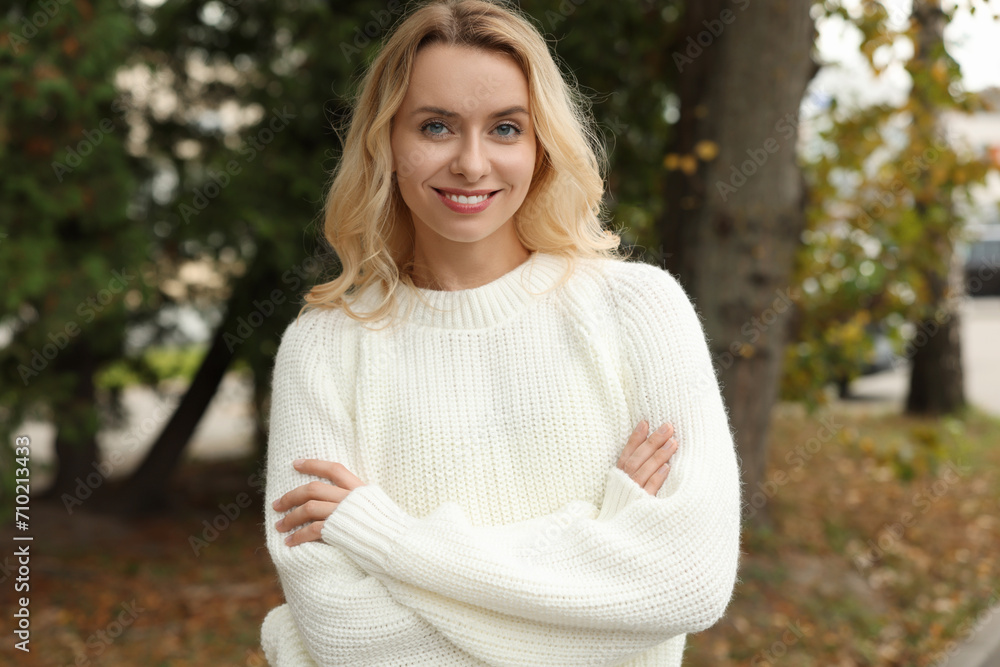 Happy woman in stylish warm sweater outdoors Happy woman in stylish warm sweater outdoors