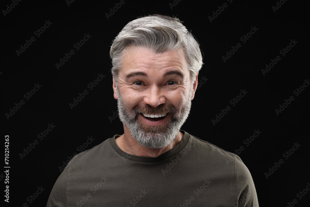 Personality concept. Portrait of happy man on black background Personality concept. Portrait of happy man on black background
